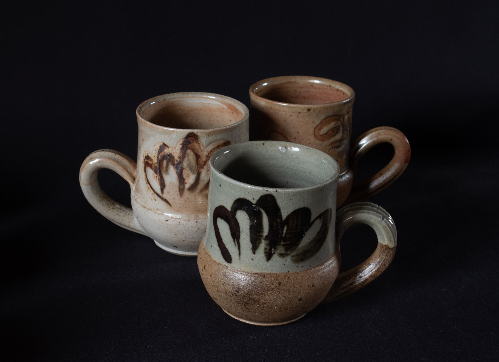 Three wood fired stoneware mugs with surface decoration