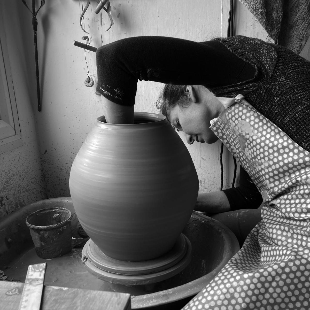 Rowena Hamilton throwing a large jar on the potter's wheel